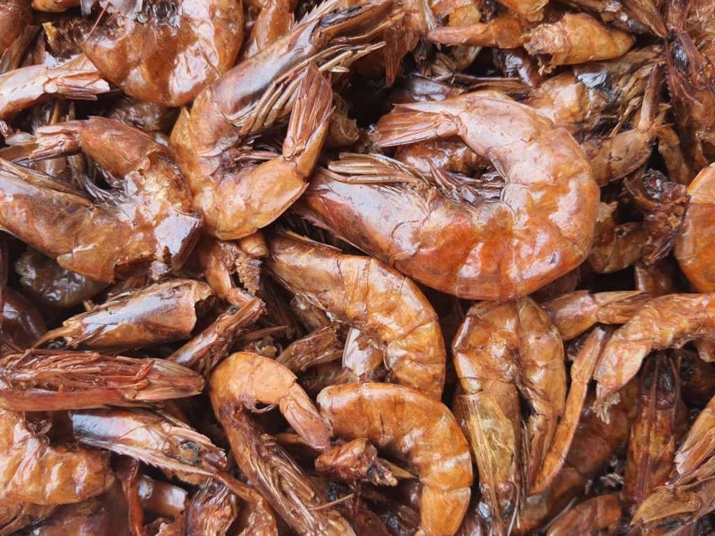 Whole dried Nigerian crayfish, rich amber and brown tones, crisp texture